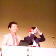 シンポジウムの壇上でシャア大佐のマスクを装着する筆者、日本が誇るレジェンドな来賓を前に一生分の勇気を使い果たす